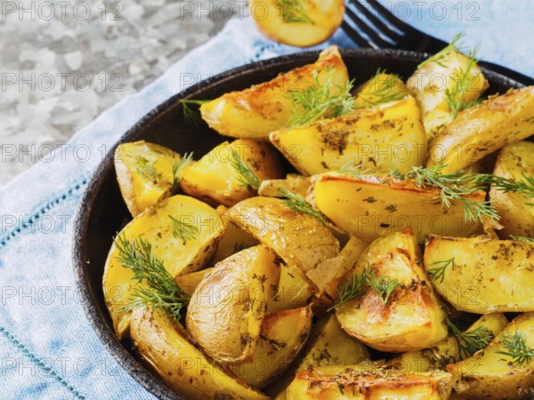 Close up view of backed potatoes in cast iron skillet