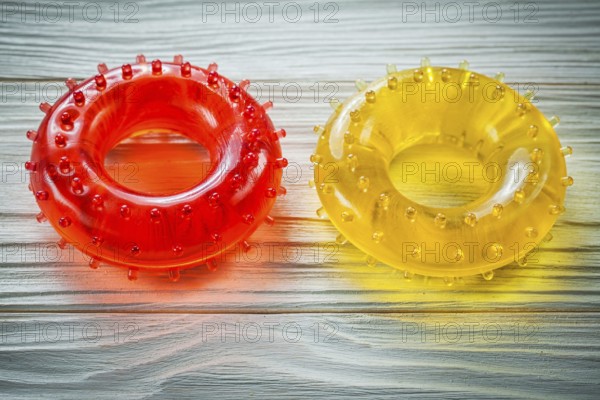 Rubber round hand expanders on wooden board sports training concept
