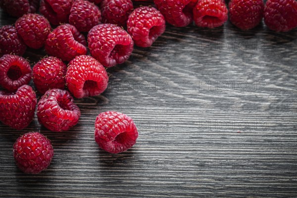 Heap of raspberries on wooden background