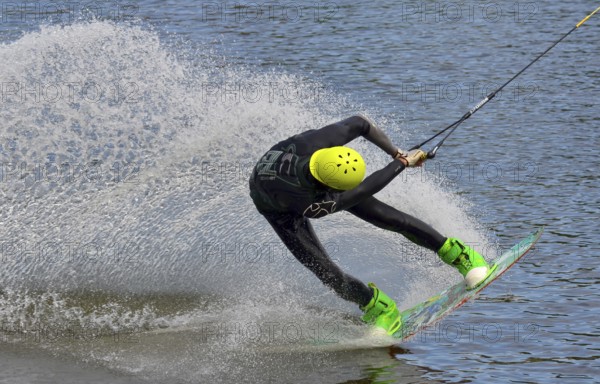 Russia, Volgodonsk - June 18, 2015: Water snowboard. The athlete with snowboard hold on to the rope and the boat accelerates