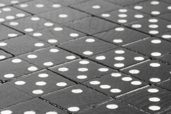 Composition of lying black domino bricks with white dots