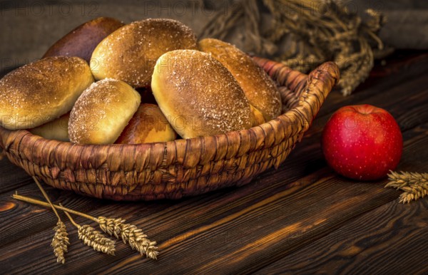 Ukrainian baked pies in wicker basket on wooden table