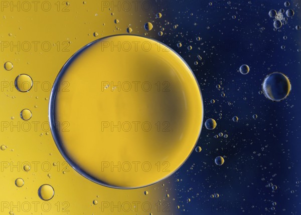 Abstract macro with oil drops in water, looking like planets in space