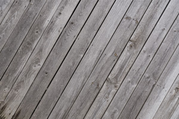 Crooked weathered old wooden wall - text space, close-up