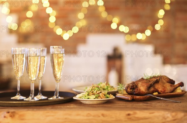 Winter holiday family dinner with roast poultry and champagne