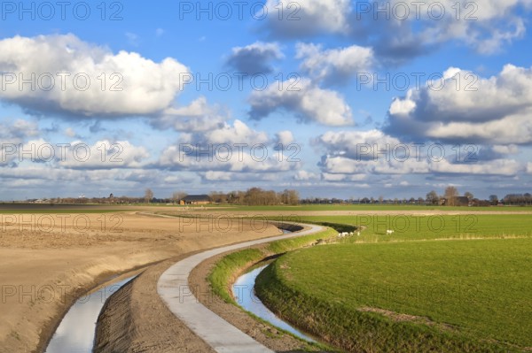 Curved road under blue sky with nice cloudscape, Netherlands