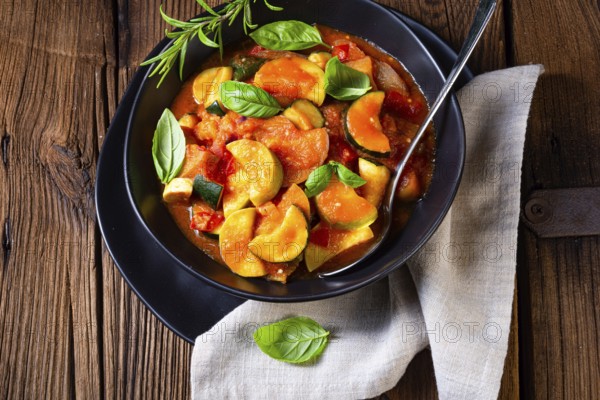 Vegetarian courgette ratatouille with tomato sauce and herbs