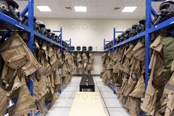 Dressing room of a fighter aircraft (jet fighter) pilot with uniforms and helmets with breathing masks