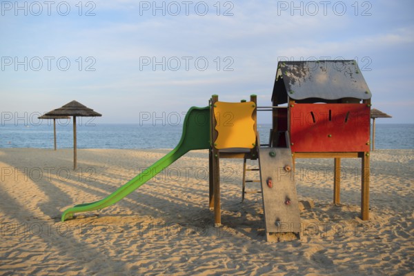 Landscape and playground on island Corsica with wicker parasols
