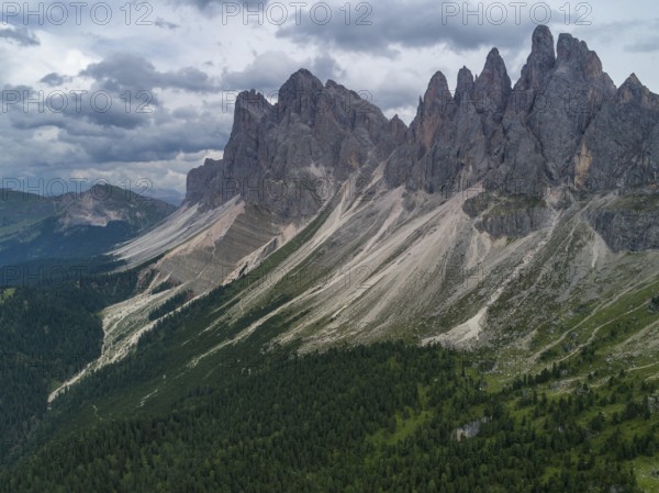 Aerial Drone photo of Santa Magdalena St Maddalena Val di Funes in Dolomites Italian Alps with Furchetta mountain peak on the background