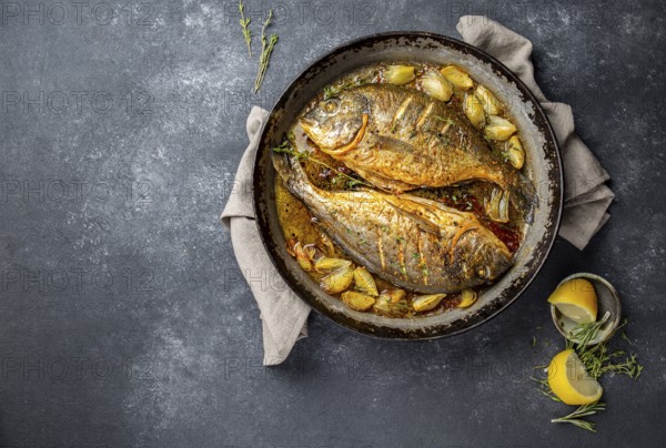 Food, Food, Baked sea bream or dorada with onion and herbs in pan on dark background