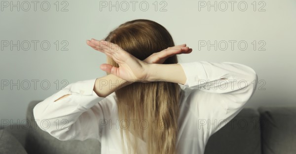 Close-up upset young woman shows stop, no or enough sign with palm of hand, refusal gesture, domestic violence