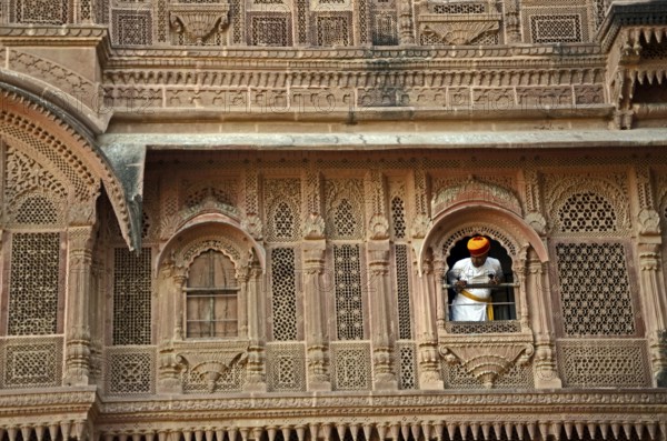 Man peeping out of palace window at Mehrangarh Fort, Jodhpur, Rajasthan, India, Asia