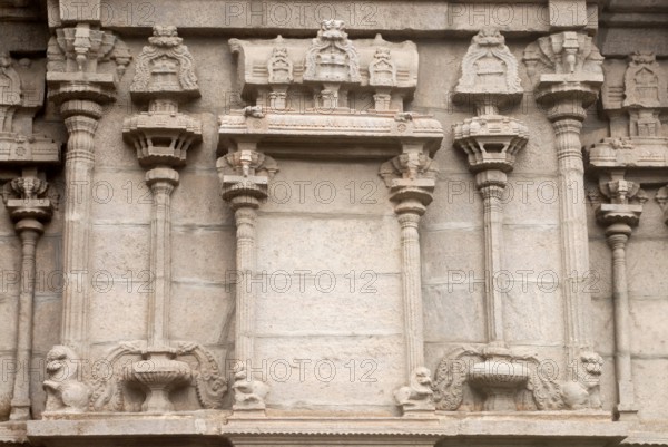 Richly relief stone carved pillars and mandapam on the wall of south gopuram of Shree Meenakshi Sundareswarar temple, Madurai, Tamil Nadu, India