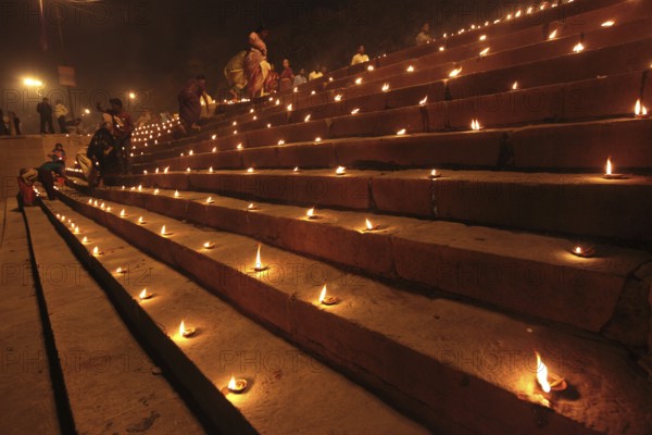 Earthen lamps on staircase to celebrate Dev Deepavali on Ganga River at Varanasi Uttar Pradesh India