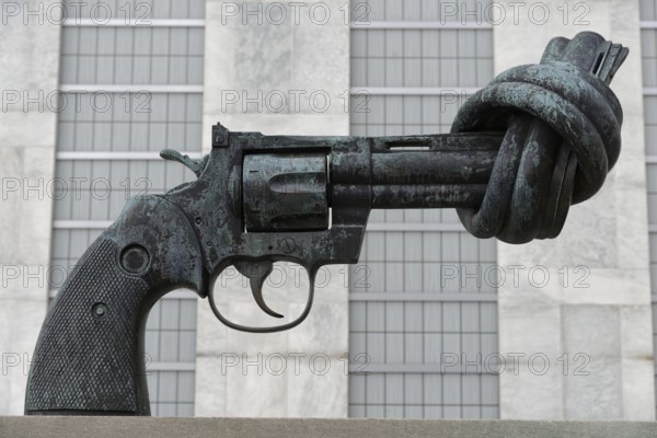 Pistol with knot in the barrel, sculpture by Carl Fredrik Reuterswärd in front of the UN headquarters, close-up view of a sculpture depicting a knotted revolver, Manhattan, New York City, New York, USA, North America