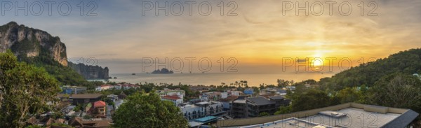 Tropical sea sunset at Ao Nang Beach with limestone mountain, Krabi Thailand high angle view nature landscape panorama