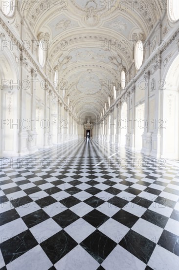 Reggia di Venaria Reale, Italy, October 2022: corridor perspective, luxury marble, gallery and windows, Royal palace