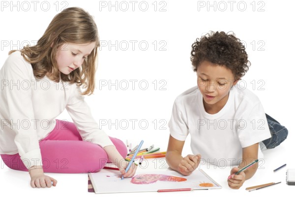 Interracial children drawing together, isolated on white