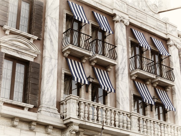 Windows with canopies of a house built in Venetian gothic architectural style