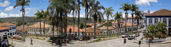 Panorama of traditional houses and palm tree lined street in historic center of Diamantina on a sunny day, Minas Gerais, Brazil