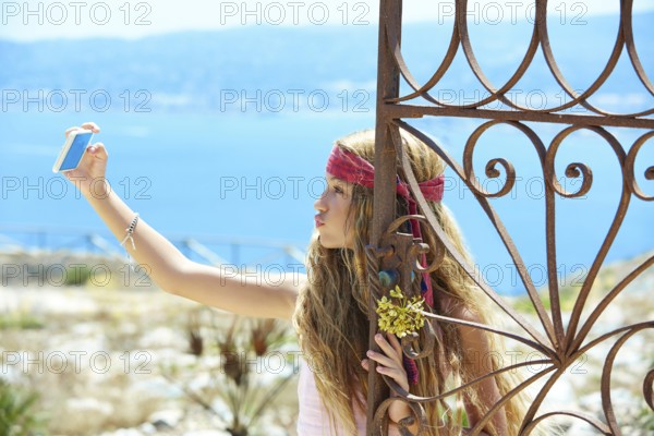 Blond girl selfie photo in mediterranean sea gate at Spain