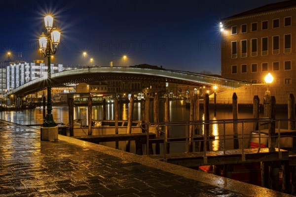 Illuminated bridge over the Grand Canal with lanterns and jetties at night, Fondamenta S. Simeon Piccolo, Venice, Veneto region, Italy