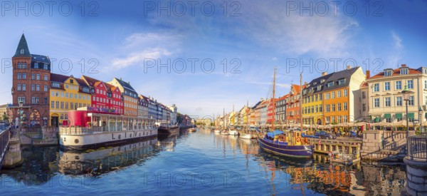 Panorama of the Nyhavn canal with boats, ships and many small colorful houses. Copenhagen, Denmark