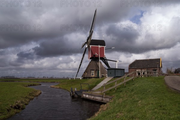 Heavy clouds above the Hoogmadese windmill near the Dutch village Hoogmade