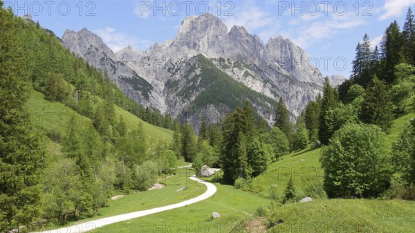 Dyllic hiking trail in the Klausbach valley near Ramsau (near Berchtesgaden) with a view of the large mill tower