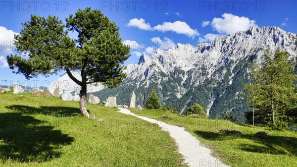 Rock garden on the hiking trail from Lautersee to Mittenwald with Karwendel mountains and huts