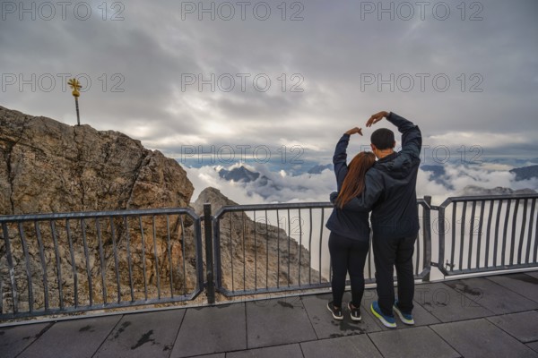 Zugspitze Peak top of Germany and Alps mountain range with love couple tourist, Garmisch Partenkirchen Germany