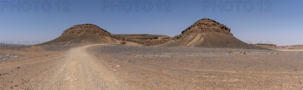 Iconic horseshoe mountain Gara Medouar in the desert near Merzouga, known for different film sets, Morocco