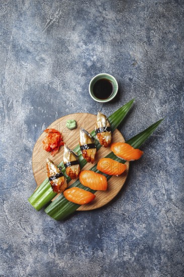 Food, Sashimi sushi set on wooden board. Stone background. Top view