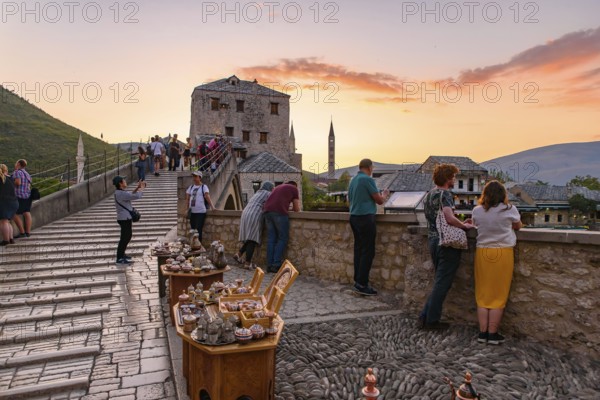 People on the old bridge watching sunset in Mostar, Bosnia and Herzegovina