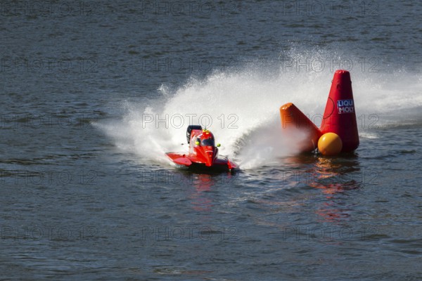 PESO DA REGUA, PORTUGAL - SEPTEMBER 15, 2024: Red Powerboat Makes Sharp Turn with Splashes of Water during Race. Red Buoy. Formula 2 World Championship