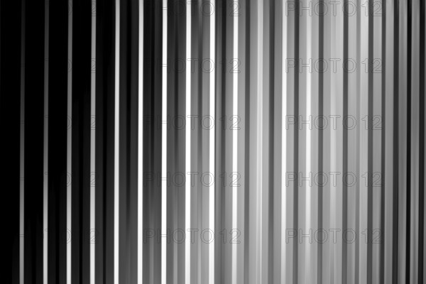 An abstract black, white and grey striped surface with shadows and vignettes