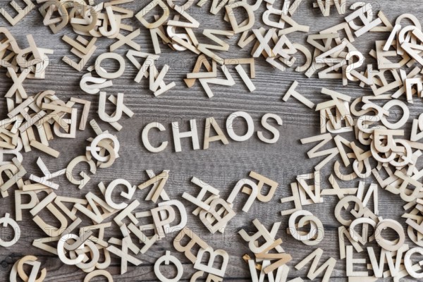 An image of some wooden letters and the word chaos