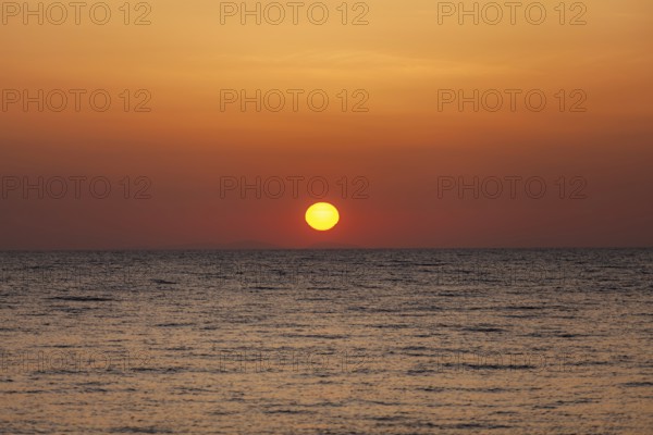 Sunrise over the sea, view from Kamari, island of Santorini, Cyclades, Greece