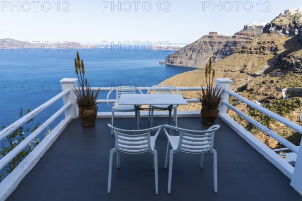 Table and armchair, viewpoint on the crater rim, Fira, Santorini Island, Cyclades, Greece