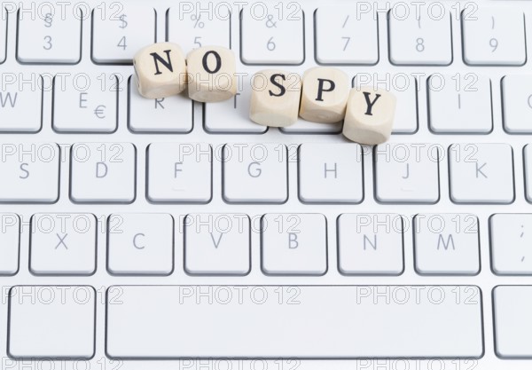 The photo shows a keyboard with wooden letters with the words