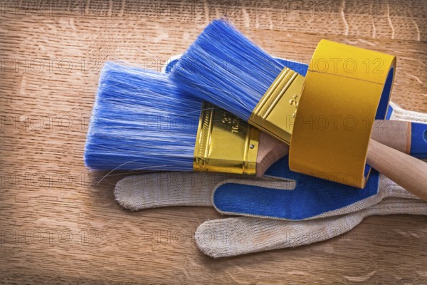 Set of protective gloves with paint brushes in duct tape maintenance concept