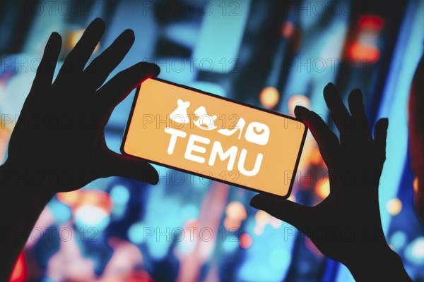 In this photo illustration, the Temu logo is displayed on a smartphone screen