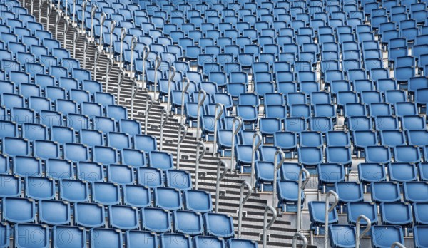 Blue plastic empty stadium or stage chairs in a row