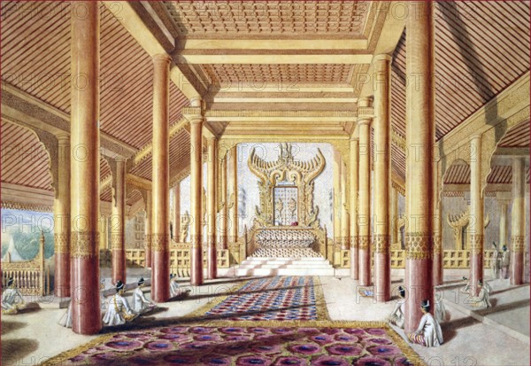 In 1855 the British sent a diplomatic mission to the court of King Mindon Min (r.1853-1878). Grant (1813-1880) was sent as the official artist of the mission. Together with a privately-printed book of notes, his drawings give a vivid account of the journey, and a number were used for illustrations to Henry Yule's ‘A Narrative of the mission sent by the Governor General of India to the Court of Ava in 1855' published in 1858.<br/><br/> Grant wrote that the audience chamber represented in this painting was 'called ‘Thee-ha-thuna-yàzà-pulleng', and used only on occasions of importance...the blaze and brilliancy of the colonnaded hall, with its choir and transepts, its elaborately ornate and singular throne, glittering in mosaic and gold...'<br/><br/> Today, little remains of the palace buildings at Amarapura