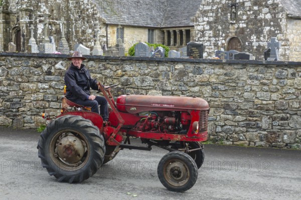 Old tractor Massey Ferguson in front of church and chapel Sainte Nonne, vintage car meeting Dirinon, department Finistere Penn ar Bed, region Bretagne Breizh, France