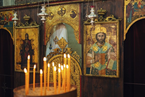 The interior of the church. Icons, chandelier, candles in a small Christian Orthodox church in Montenegro