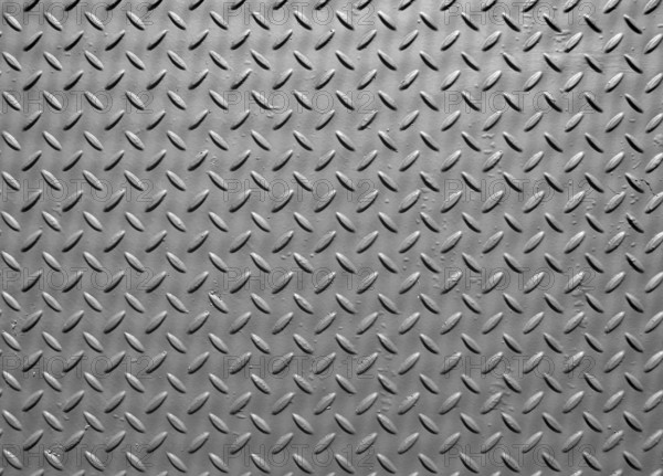 Grey steel metal plate with painted surface and industrial safety diamond pattern texture