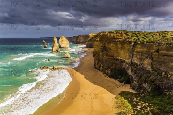 Travel to Australia. Magic light on the Pacific coast near Melbourne. Famous rocks Twelve Apostles in ocean waves surf. The concept of active and phototourism