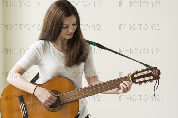 Teenager plays with a guitar - copy space